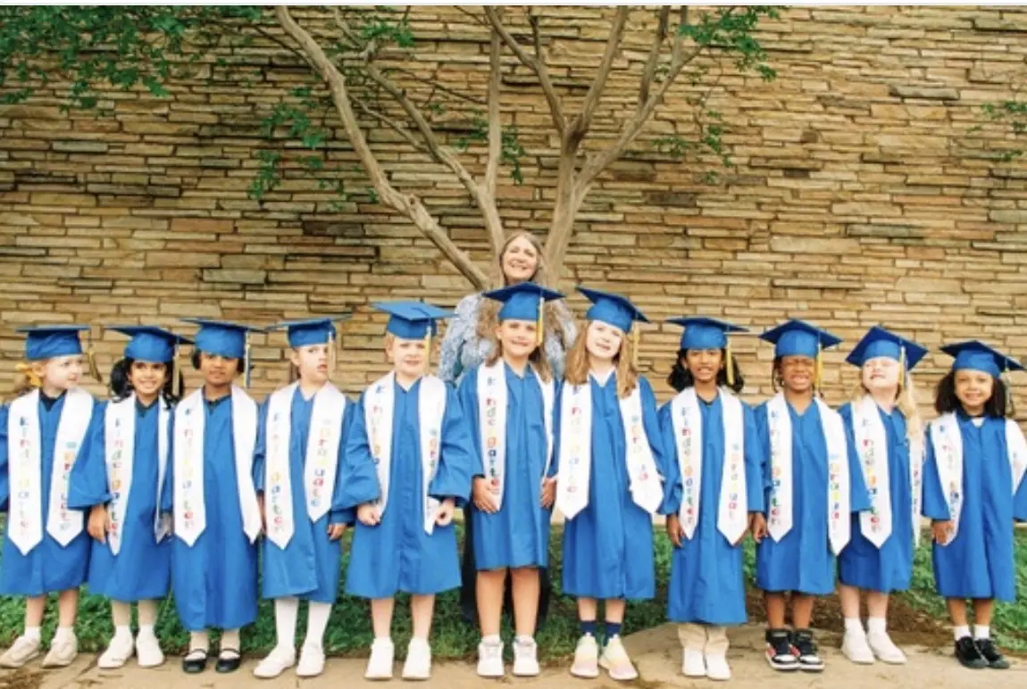Kindergarten graduates in blue caps and gowns